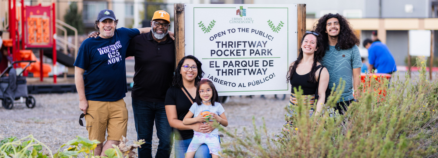 6 people in front of sign: Open to public! Thriftway Pocket Park