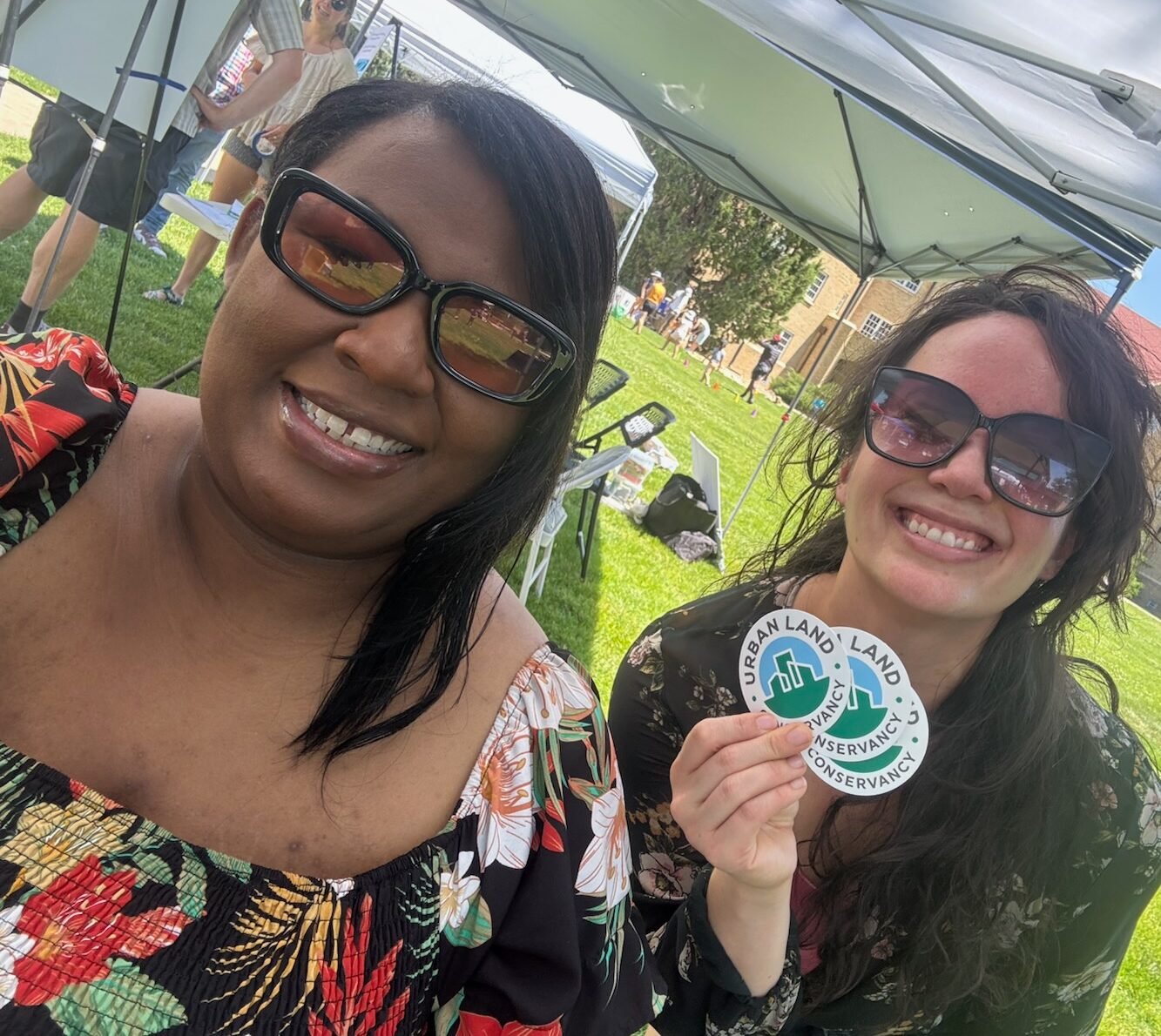 two people holding ulc rebranded stickers
