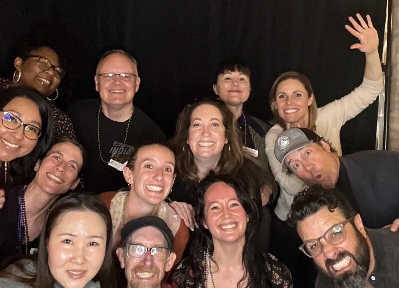 a group of 10 people mugging for the camera