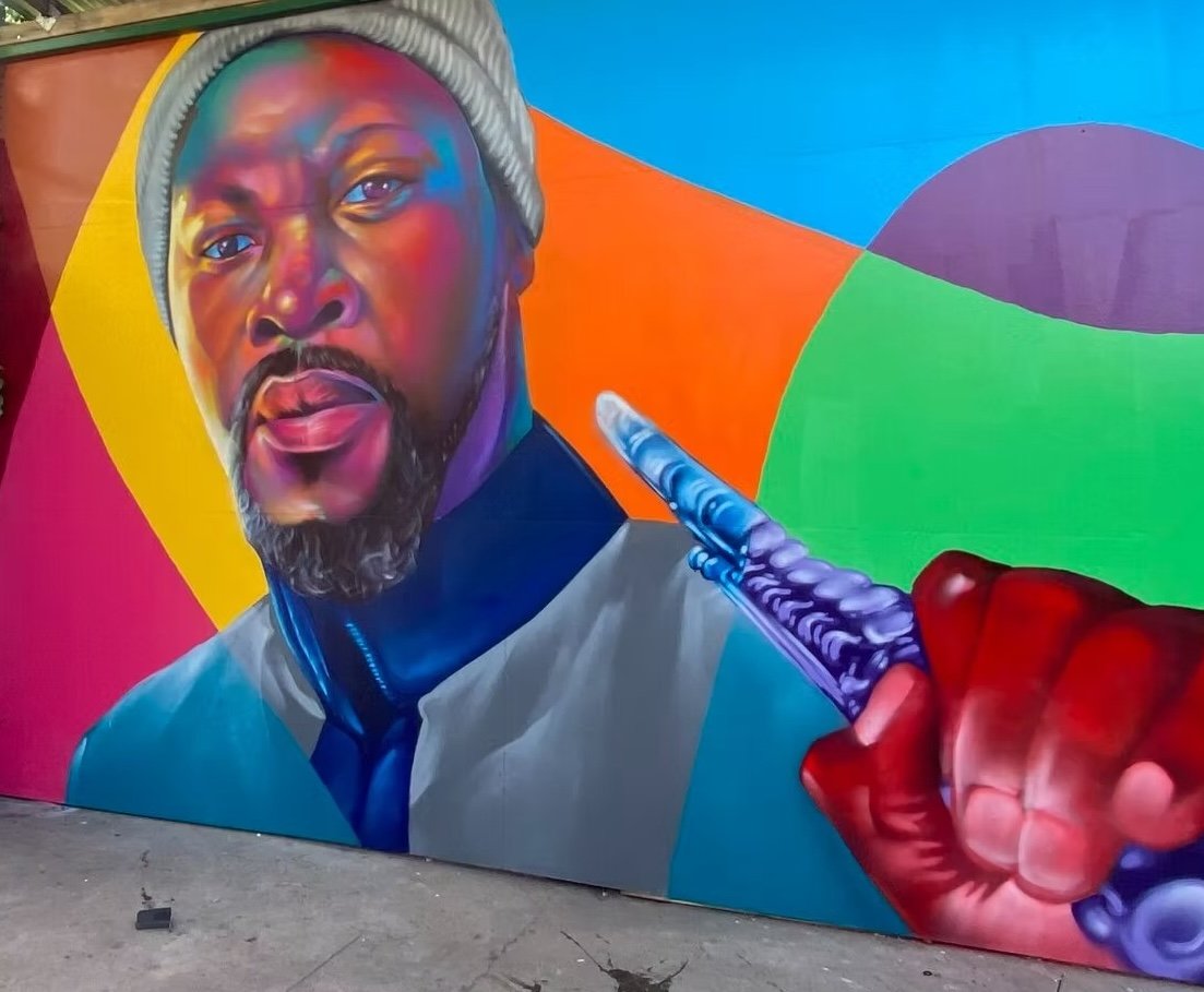 Colorful mural of a man with flute in hand