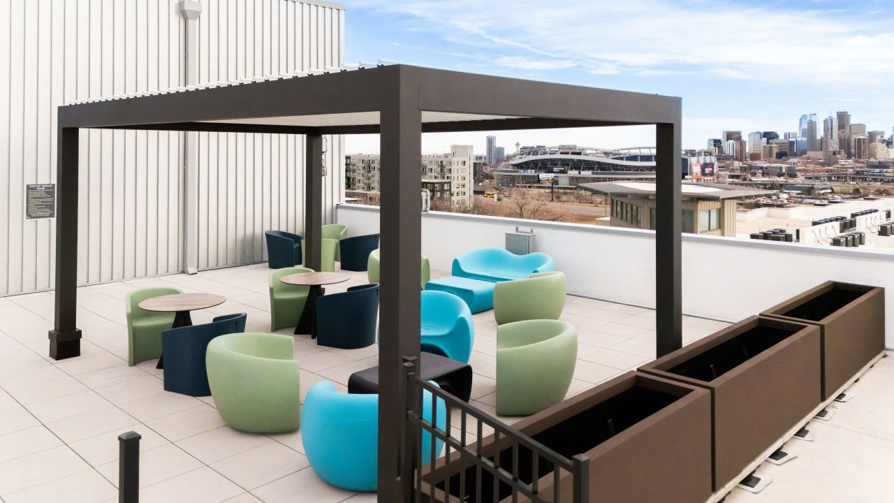 Apartment rooftop patio with the Denver Skyline and Empower Field at Mile High in the background